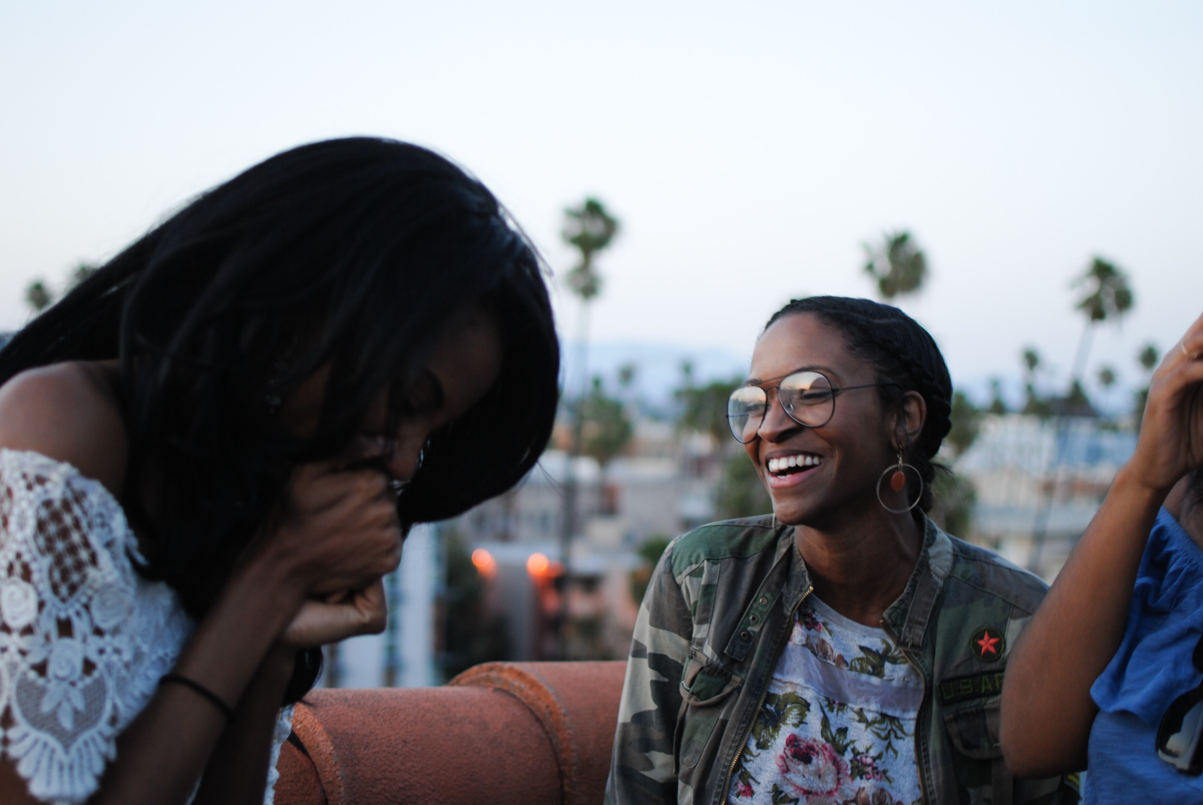 Group of women laughing together, completely relaxed, enjoying each other's company.